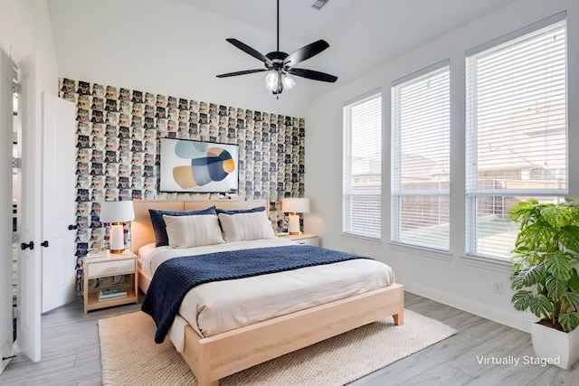 4100 Sandbrock Pkwy, Aubrey, TX 76227 - bedroom featuring multiple windows, baseboards, light wood-style flooring, and lofted ceiling