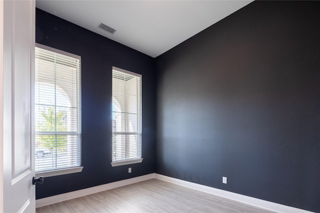 spare room with light hardwood / wood-style floors