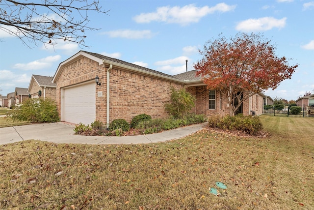 view of side of property featuring a garage and a lawn