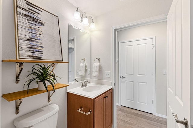 2876 Shore Shadows Ln, Frisco, TX 75036 - bathroom featuring toilet, wood finished floors, and vanity