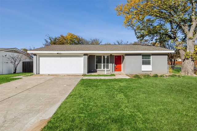 ranch-style home with a garage and a front lawn