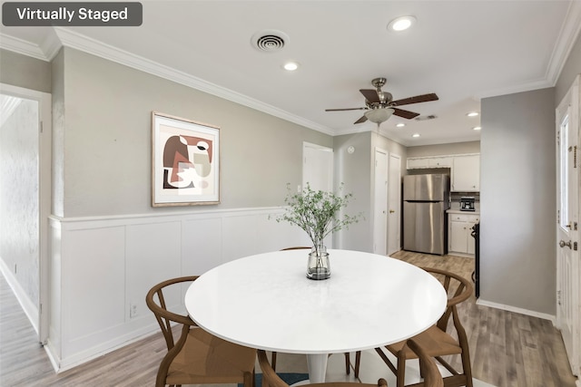 dining room with ornamental molding, light hardwood / wood-style floors, and ceiling fan