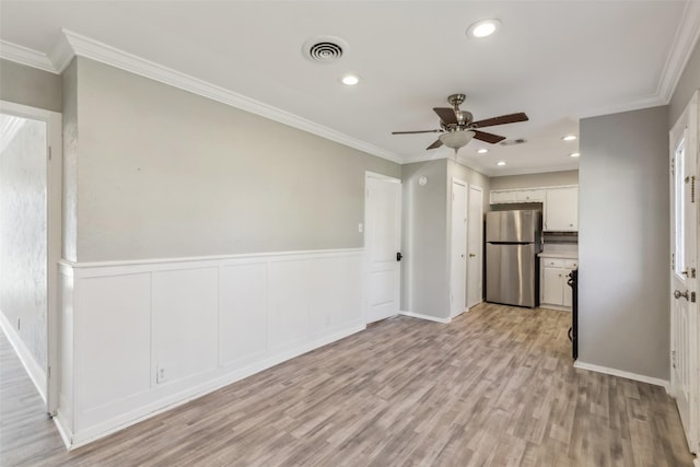 unfurnished living room featuring crown molding, ceiling fan, and light wood-type flooring