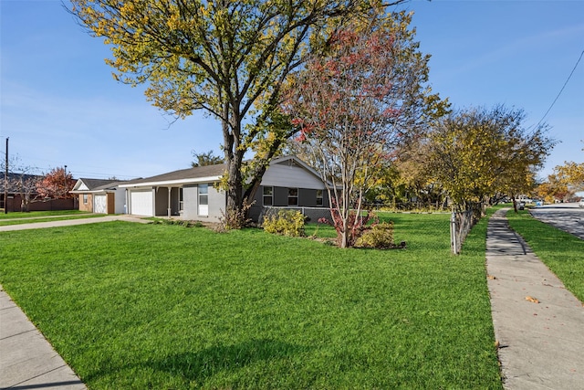 ranch-style home with a garage and a front lawn