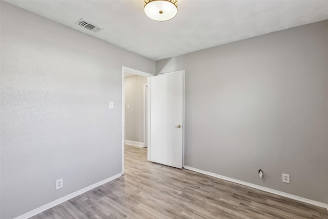 unfurnished room with light hardwood / wood-style floors