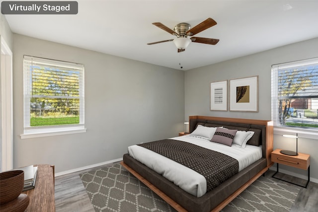 bedroom with wood-type flooring and ceiling fan