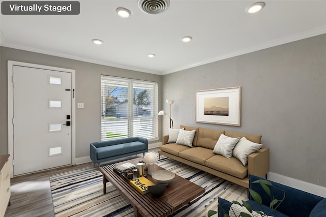 living room with light hardwood / wood-style flooring and ornamental molding