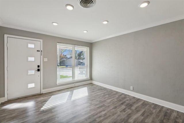 foyer entrance with crown molding and hardwood / wood-style floors