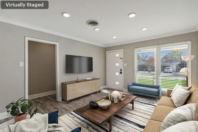 living room featuring hardwood / wood-style flooring and crown molding