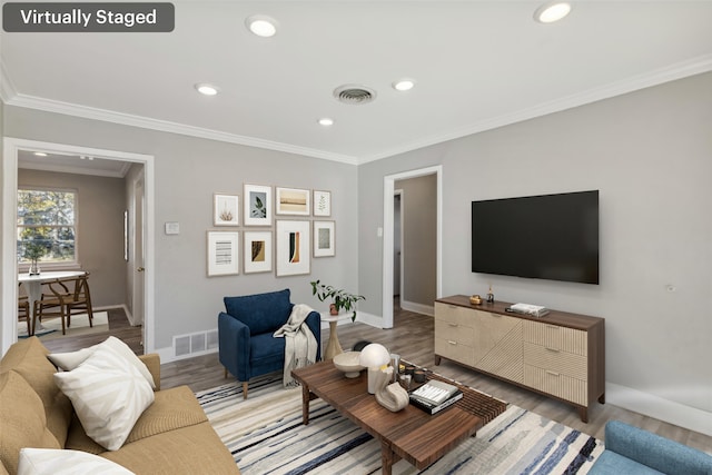 living room with hardwood / wood-style flooring and ornamental molding