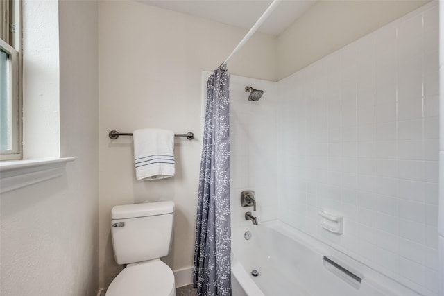 bathroom with shower / bath combination with curtain and toilet