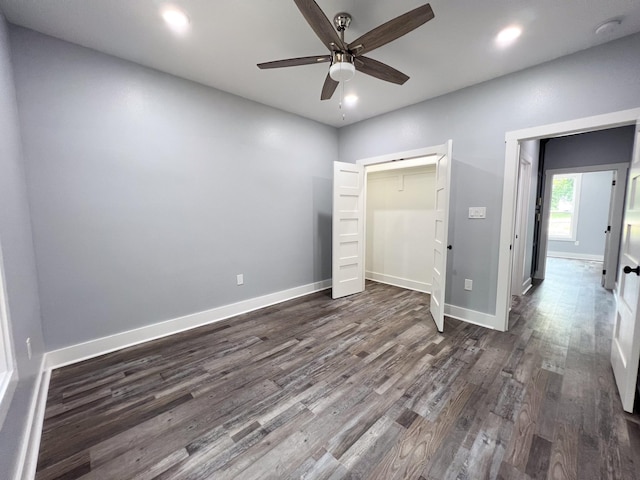 unfurnished bedroom featuring a closet, ceiling fan, and dark wood-type flooring