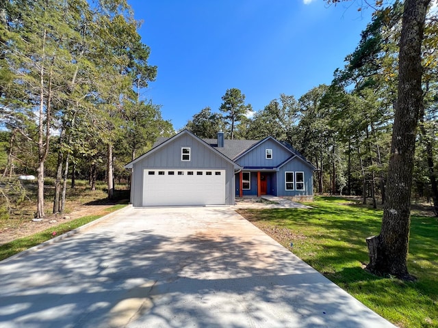 view of front of property with a front lawn and a garage