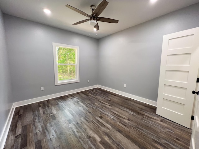 empty room with dark hardwood / wood-style floors and ceiling fan