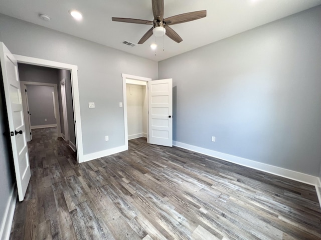 unfurnished bedroom with dark hardwood / wood-style floors and ceiling fan