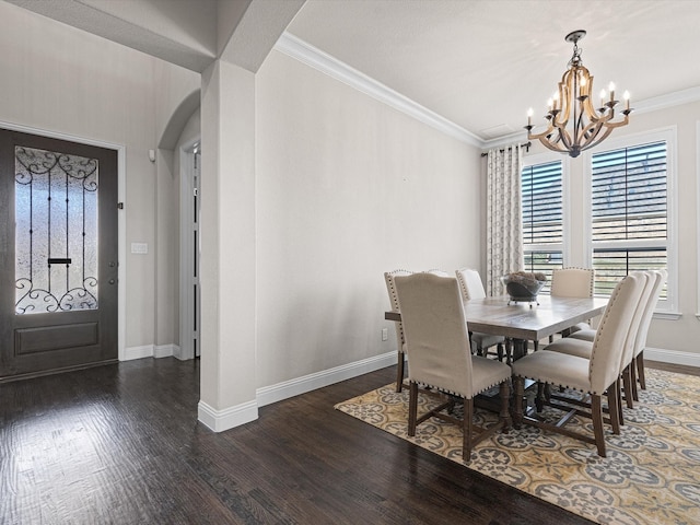 dining space featuring an inviting chandelier, crown molding, and dark hardwood / wood-style floors