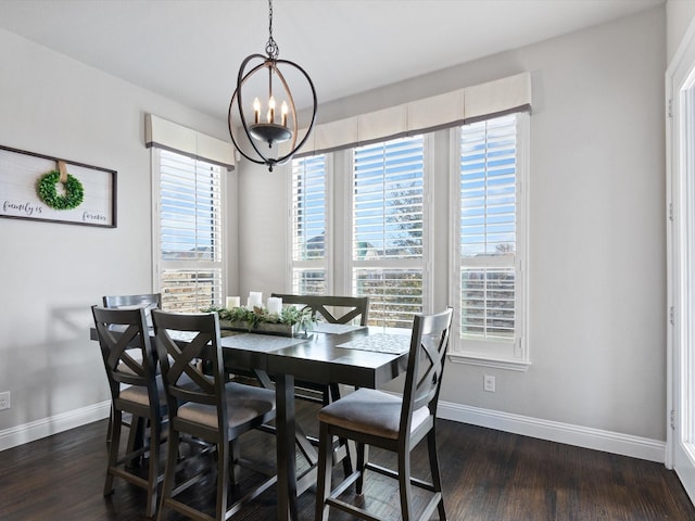 dining area featuring dark hardwood / wood-style floors and a chandelier