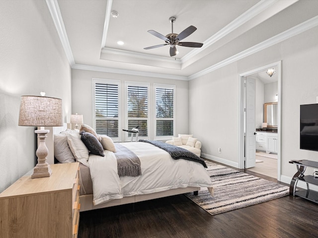 bedroom featuring ceiling fan, a raised ceiling, ensuite bathroom, hardwood / wood-style flooring, and ornamental molding