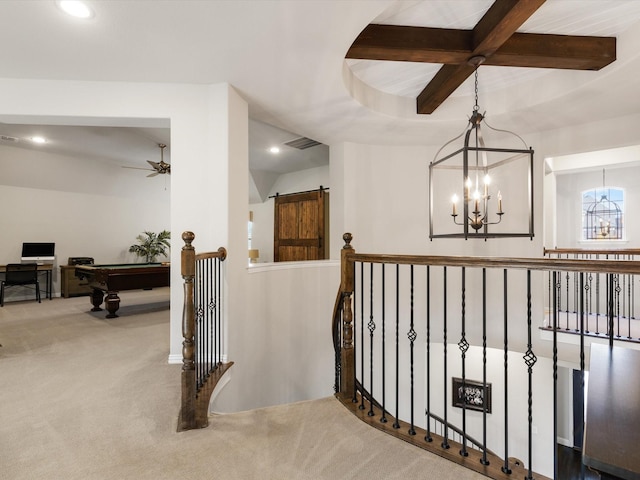 corridor featuring beamed ceiling, carpet floors, and an inviting chandelier