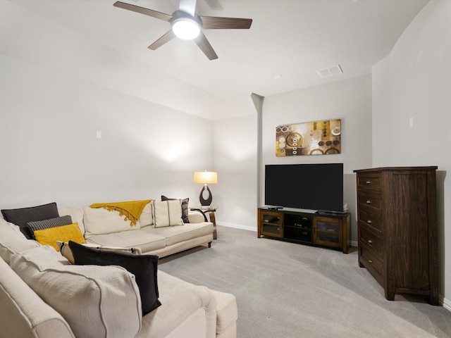 carpeted living room with ceiling fan