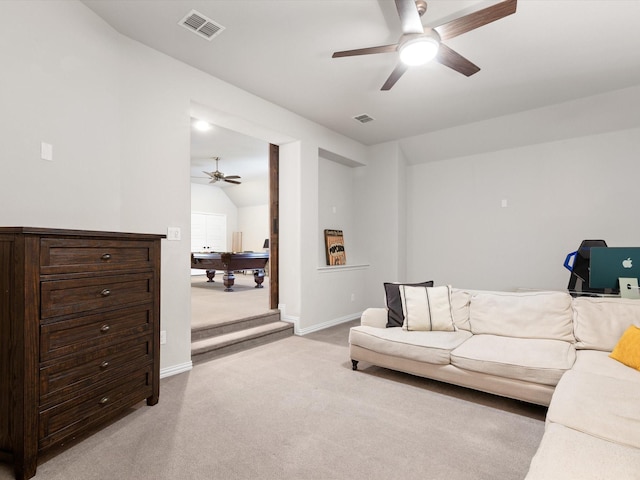 carpeted living room featuring ceiling fan and vaulted ceiling