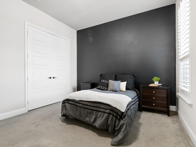 carpeted bedroom with a closet