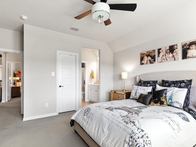 carpeted bedroom with ensuite bath, ceiling fan, and lofted ceiling