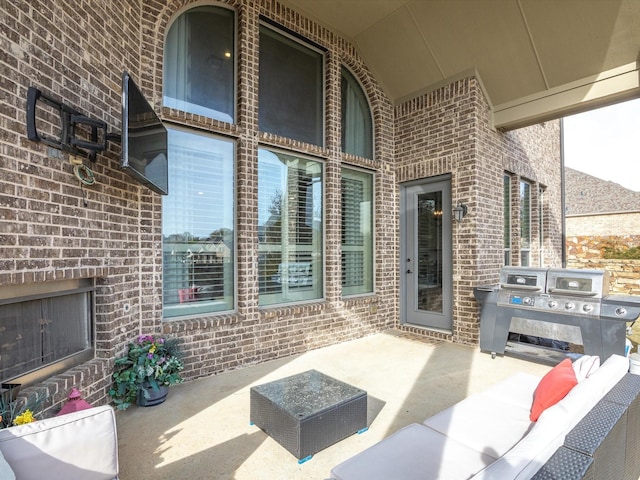 view of patio with an outdoor brick fireplace