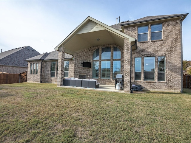 back of property with an outdoor hangout area, a patio area, and a lawn