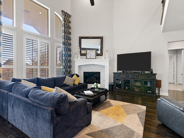 living room featuring dark hardwood / wood-style flooring and a towering ceiling