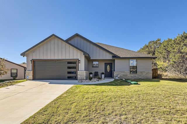 view of front of house with a front yard and a garage