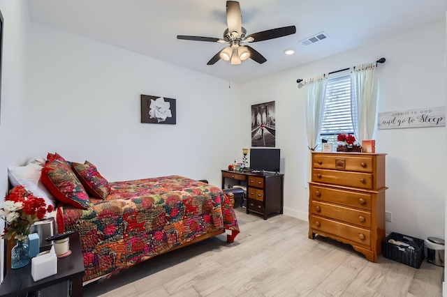 bedroom with ceiling fan and light hardwood / wood-style floors