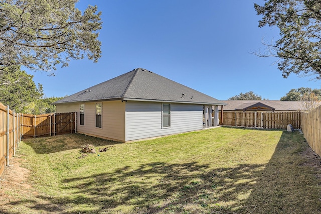 back of house with a lawn