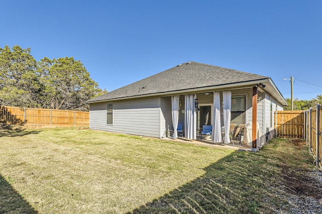 rear view of property with a lawn