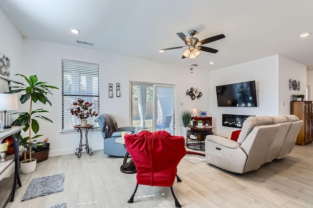 living room featuring ceiling fan and light wood-type flooring