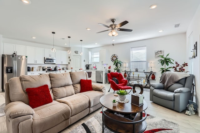 living room featuring ceiling fan and light hardwood / wood-style floors