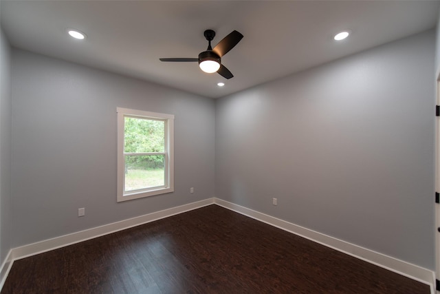 unfurnished room featuring ceiling fan and dark wood-type flooring