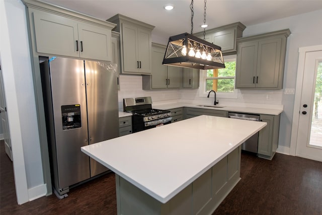 kitchen with dark hardwood / wood-style floors, gray cabinets, sink, and stainless steel appliances