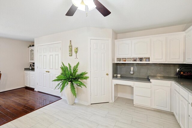 kitchen featuring decorative backsplash, light hardwood / wood-style floors, white cabinetry, and ceiling fan