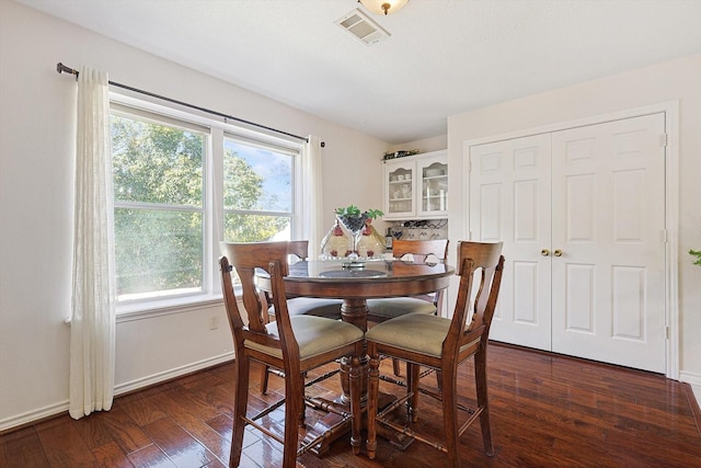 dining space featuring dark hardwood / wood-style flooring and a healthy amount of sunlight