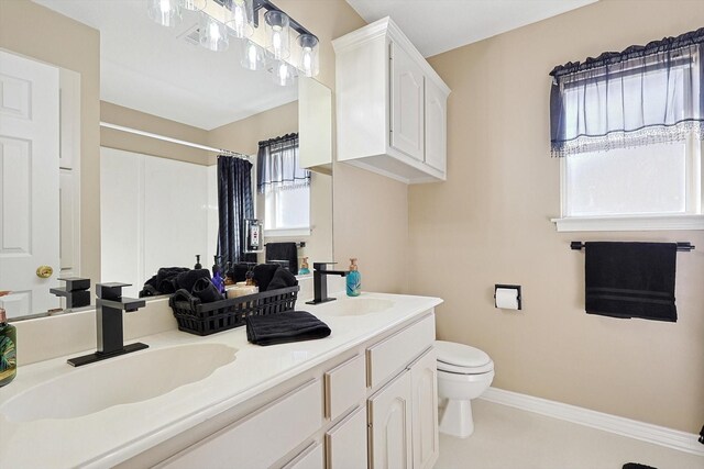 bathroom with a shower with curtain, vanity, toilet, and a wealth of natural light