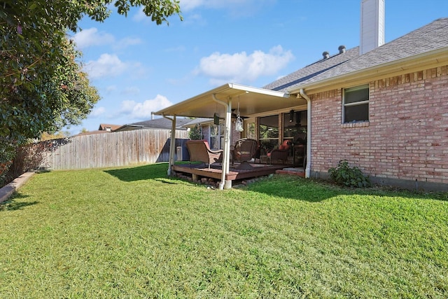 view of yard featuring ceiling fan and a wooden deck