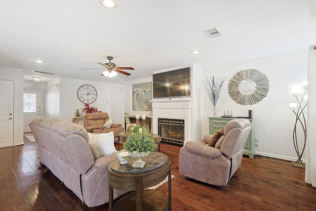 living room featuring ceiling fan and dark hardwood / wood-style flooring