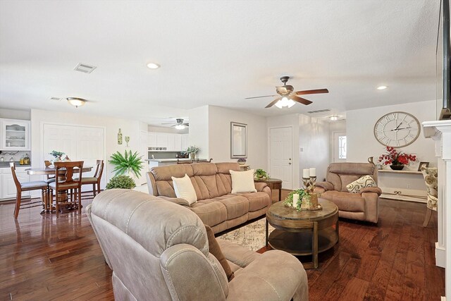 living room featuring dark hardwood / wood-style floors and ceiling fan