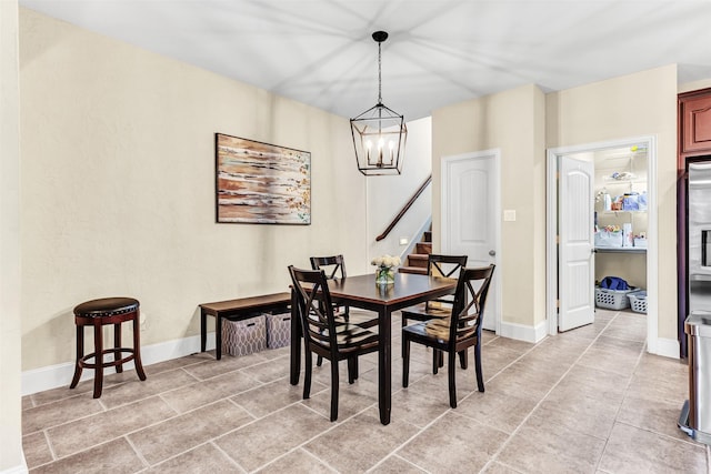 dining space featuring a notable chandelier and light tile patterned flooring