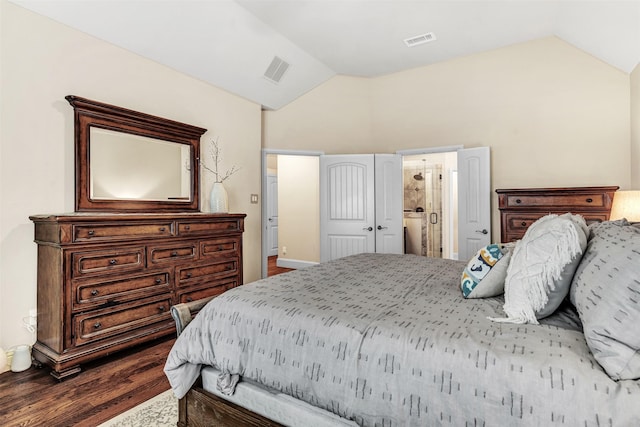 bedroom with a closet, wood-type flooring, lofted ceiling, and ensuite bath