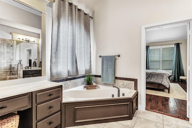 bathroom featuring vanity, a bathtub, and wood-type flooring