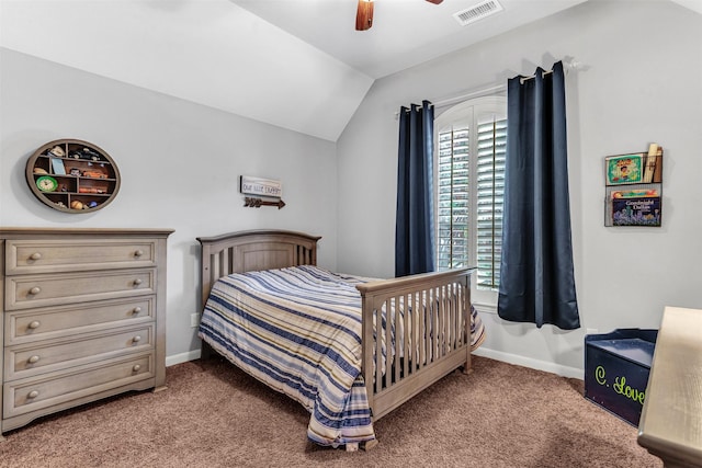 carpeted bedroom with ceiling fan and vaulted ceiling