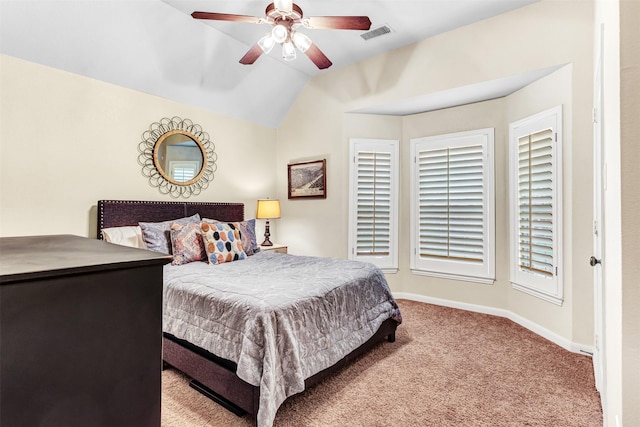 carpeted bedroom with ceiling fan and vaulted ceiling