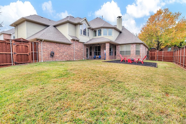 rear view of property with a lawn